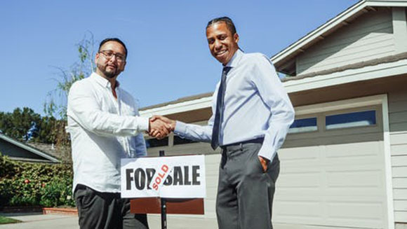 A client and real estate agent closing a deal